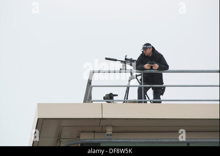 Manchester, UK. 30th Sept, 2013. A police 'sniper' positioned on the roof of the Premier Inn hotel on Lower Mosley Street opposite the Manchester Central exhibition centre observes the streets below. The exhibition centre was hosting the Conservative Party Conference in September 2013. Credit:  Russell Hart/Alamy Live News. Stock Photo