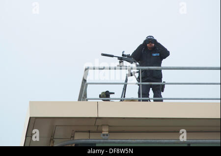 Manchester, UK. 30th Sept, 2013. A police 'sniper' positioned on the roof of the Premier Inn hotel on Lower Mosley Street opposite the Manchester Central exhibition centre observes the streets below. The exhibition centre was hosting the Conservative Party Conference in September 2013. Credit:  Russell Hart/Alamy Live News (Editorial use only). Stock Photo