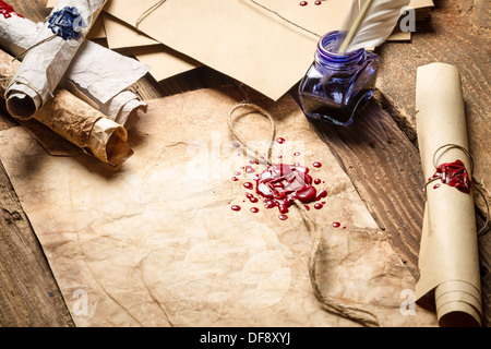 Old scrolls, sealing wax and blu ink on wooden table Stock Photo