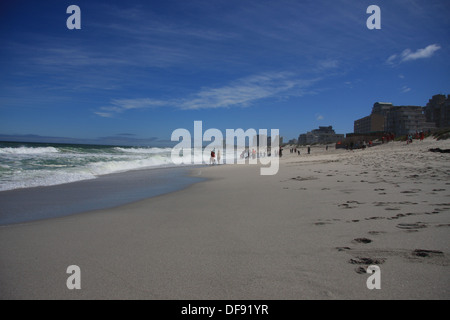 A group of people enjoying a morning on Table View beach, Cape Town, looking towards Bloubergstrand. Stock Photo