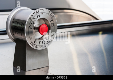 Red stop button at the top of modern train station escalators. Stock Photo