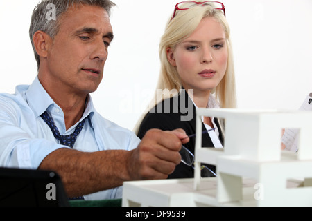 Architects examining a model Stock Photo