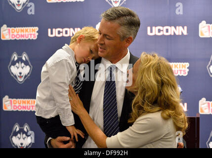 Sept. 30, 2013 - Storrs, CT, USA - Monday September 30, 2013: New UConn interim head coach and former offensive coordinator T.J. Weist,(center), son James, left, and his wife Karen, (right) by his side, share a moment after the press conference naming him interim UConn football head coach, at the Burton Family Football Complex in Storrs, CT. Bill Shettle/ Cal Sport Media. Stock Photo