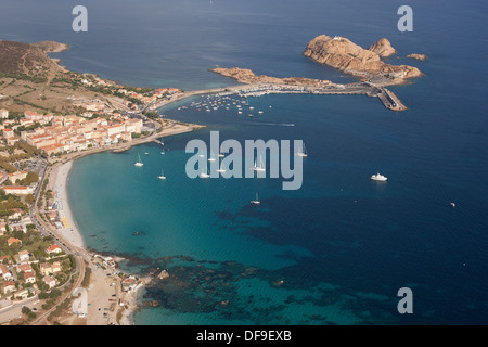 AERIAL VIEW. City of Île Rousse with its old town, beaches, marina, and ferry terminal. Corsica, France. Stock Photo