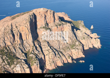 AERIAL VIEW. Rocky promontory crowned with a Genoese tower, 331-meter-high above the Mediterranean Sea. Capo Rosso, aka Capu Rossu, Corsica, France. Stock Photo