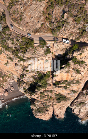 AERIAL VIEW. Vertiginous road, a dizzying 145-meter-high above the Mediterranean Sea. Gulf of Porto. Corsica, France. Stock Photo