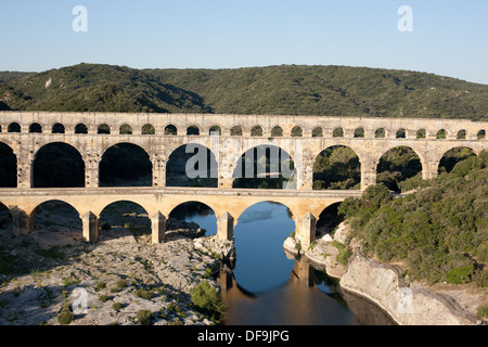 AERIAL VIEW. Roman aqueduct bridge over the Gard (aka Gardon) River. On the UNESCO world heritage list. Pont du Gard, Occitanie, France. Stock Photo