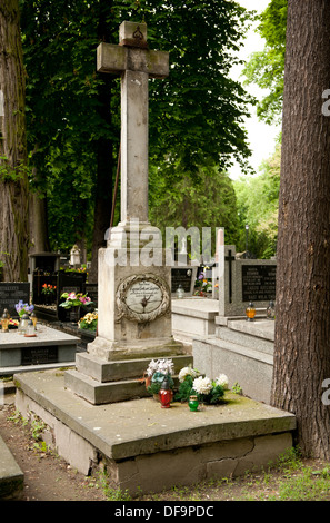 broken signboard on high cross of grave Stock Photo