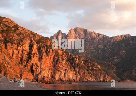 Capu d'Orto, an impressive 1293-meter-high mountain standing only 2.6km from the seashore. At sunset, after the storm. Ota, Corsica, France Stock Photo