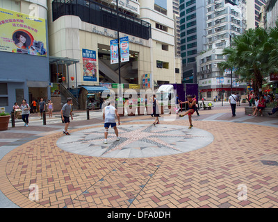 Locals playing haken sac on a Saturday afternoon in the open area outside the Sheung Wan market Stock Photo