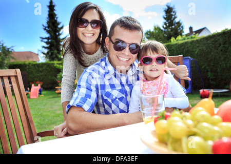 young family eating in the garden Stock Photo