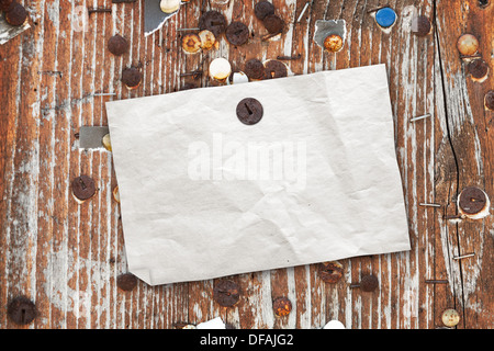 Empty paper ad hanging on brown vintage wooden billboard Stock Photo