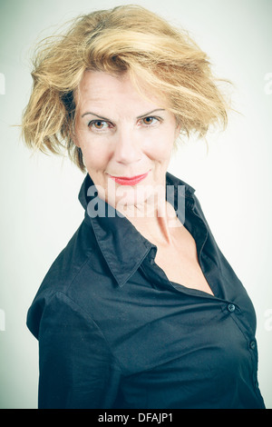 Smiling middle-aged woman with wild hair Stock Photo