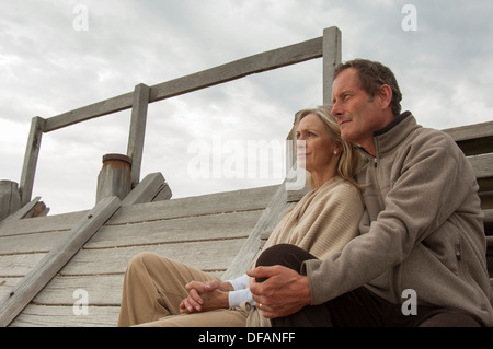 mature couple sitting looking into the distance Stock Photo