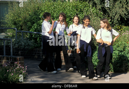 group of teenage schoolgirls walking out of school Stock Photo