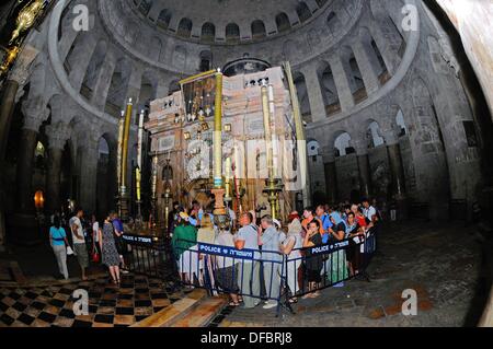 The most important site of the Church of the Holy Sepulchre is the Aedicule (Holy Grave, Grave Chapel), the supposed location of Jesus' grave and the 14th statio of the Via Dolorosa, that is visited by thousands of pilgrims and tourists daily, in Jerusalem, Israel, 12 September 2013. The Via Dolorosa (Way of Suffering) is a street in the old town of Jerusalem named after the path Jesus of Nazareth walked to his crucification. Jesus carried the cross, on which he later died via that road from the Antonia Fortress, then seat of Pilate, to Golgotha, the place where his grave is supposedly located Stock Photo