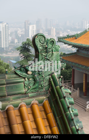 Yuejiang Lou, Nanjing, China. Detail of roof on the Yuejiang Lou with view on a foggy Nanjing skyline. Stock Photo