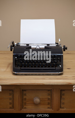 An old retro typewriter with a piece of blank paper for you to add your own text. Stock Photo