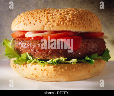 Hamburger in a sesame bun with onions and ketchup Stock Photo
