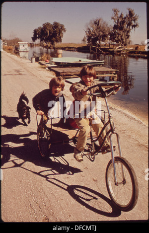 CHILDREN OF FISHERMEN ON HOMEMADE TRICYCLE 545972 Stock Photo