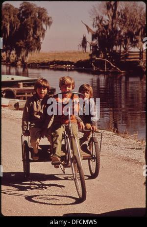 CHILDREN OF FISHERMEN ON HOMEMADE TRICYCLE 545973 Stock Photo