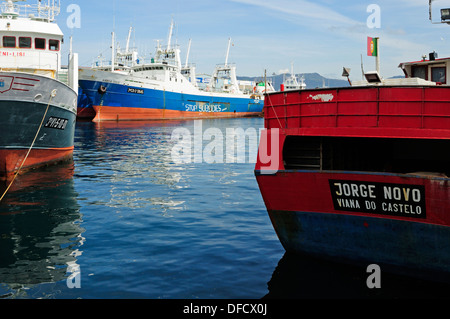 Fishing ships tied to the docks with an environmental graffiti on the hull. Vigo, Galicia, Spain Stock Photo