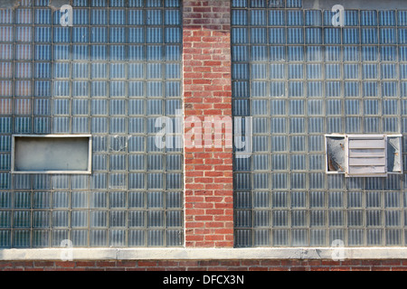 Glass bricks on the side of a factory. Stock Photo