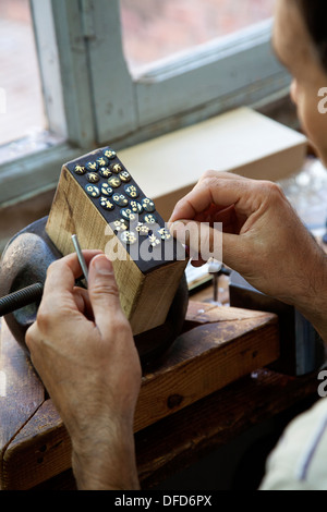 Jeweler working at his bench in Toledo, Spain. Stock Photo