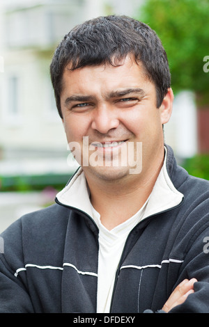Cute male 30 years old, standing outdoors Stock Photo