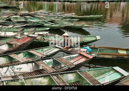 sightseeing boats docked on the Tam Coc River in Ninh Binh, Vietnam Stock Photo