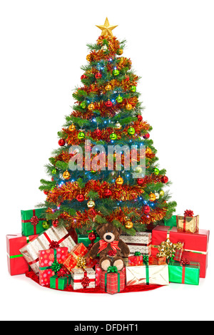 Christmas tree isolated on white with gift wrapped presents underneath Stock Photo
