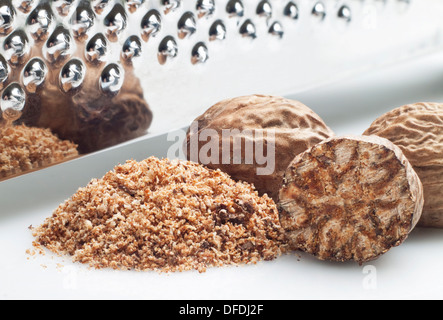 Selection of nutmeg with stainless steel hand grater Stock Photo