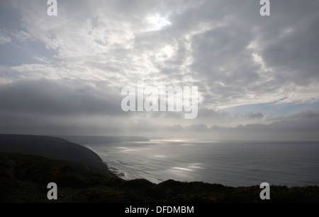 Seascape clouds sunlight breaking through broken cloud Cornwall England Stock Photo