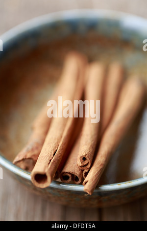 cinnamon sticks in a bowl Stock Photo