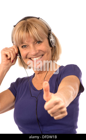 Senior woman 50-60years listening to music with stereo headphones on white background. Stock Photo