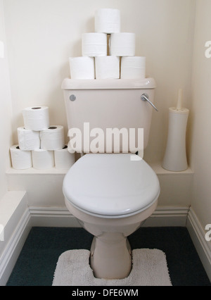 Spare toilet rolls on top of toilet. Stock Photo