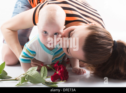 Beautiful mother kissing sweet baby boy Stock Photo