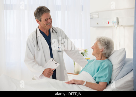 Doctor talking to elderly patient in hospital Stock Photo