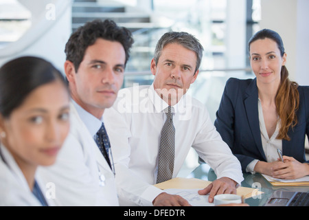 Portrait of doctors and business people in meeting Stock Photo
