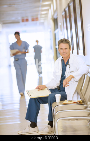 Portrait of serious doctor in hospital corridor Stock Photo