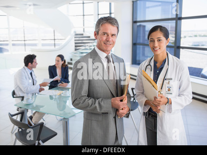 Portrait of smiling businessman and doctor in meeting Stock Photo