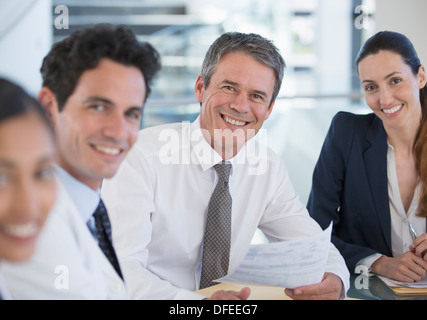Portrait of smiling doctors and business people in meeting Stock Photo