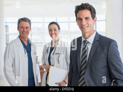 Portrait of confident businessman and doctors Stock Photo