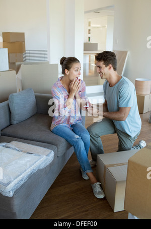 Man proposing to girlfriend in new house Stock Photo