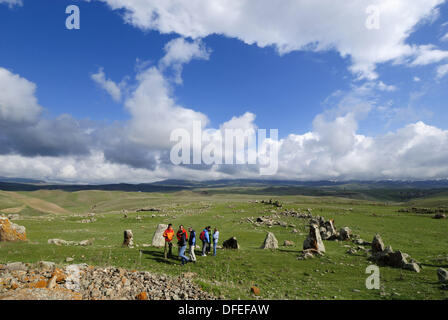 tourist group at Zorats Karer, 6000 B.C. stoneage observatory, menhir of Karahunj, Cara Hunge, Armenia, Asia