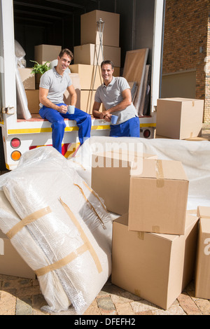 Movers sitting in moving van in driveway Stock Photo