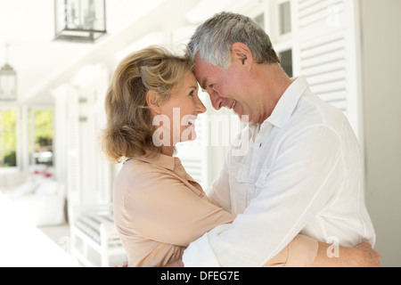 Senior couple hugging on patio Stock Photo