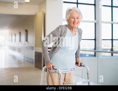 Senior patient using walker in hospital Stock Photo