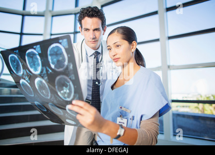 Doctor and nurse viewing head x-rays on hospital staircase Stock Photo