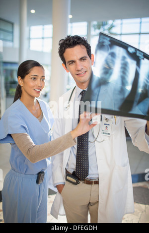 Doctor and nurse viewing head x-rays Stock Photo